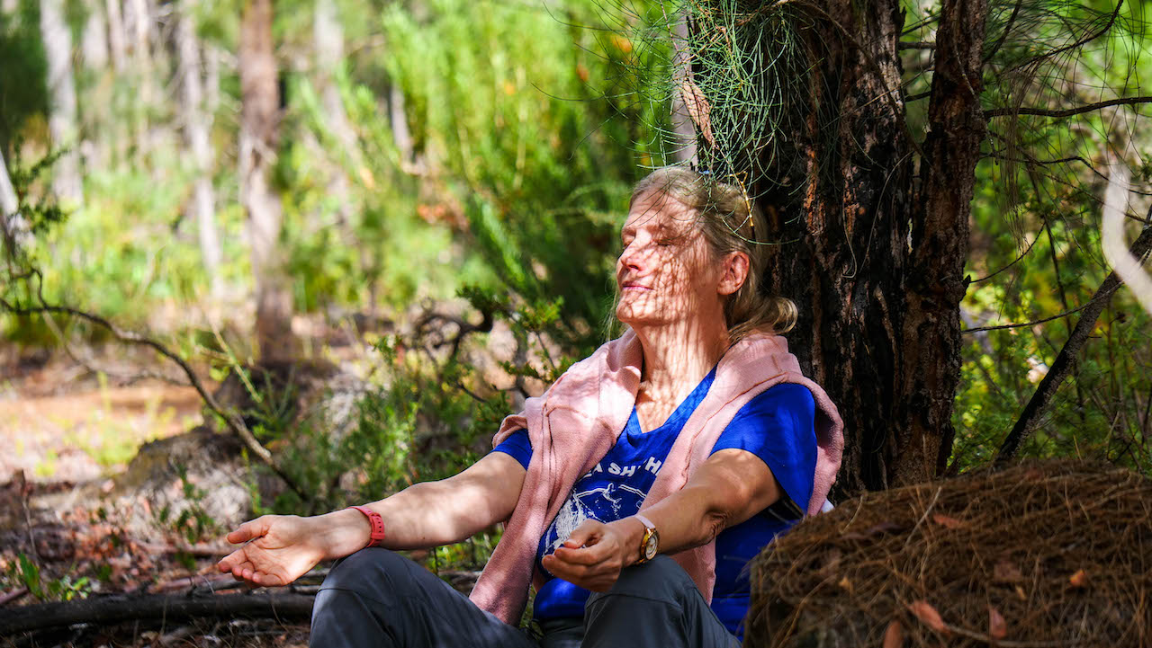 Christina meditating in the forrest